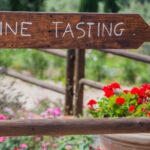 wine tasting sign with flowers in the background