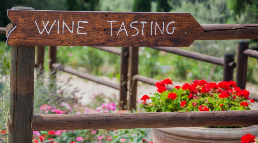 wine tasting sign with flowers in the background