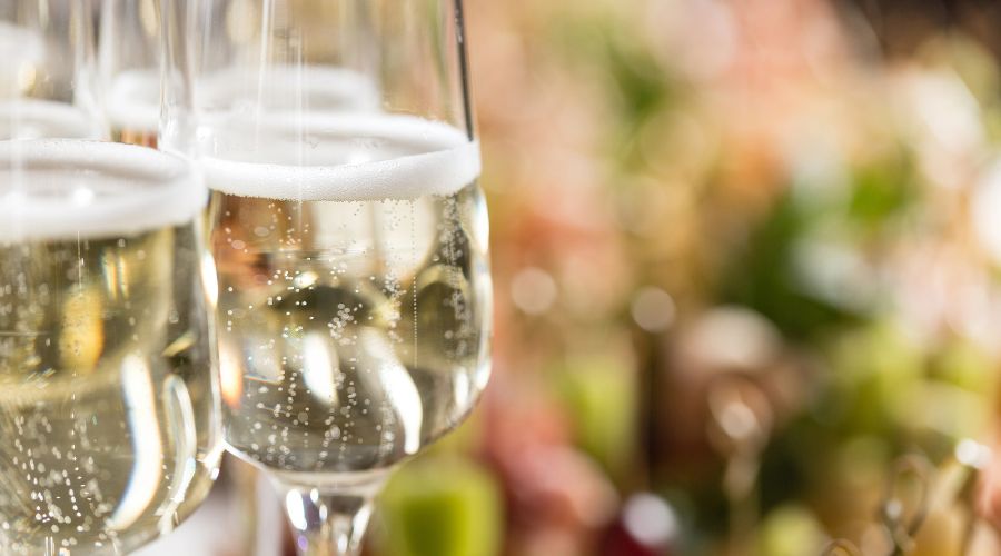 close up of white wines in glasses