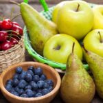 bowls of apples, pears, cherries, blueberries and raspberries