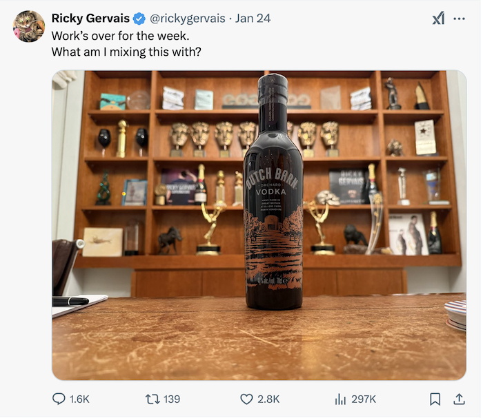 screen grab of Ricky Gervais post on X, showing a bottle of Dutch Barn Vodka with a trophy cabinet in the background. Caption reads: Work's over for the week. What am I mixing this with?