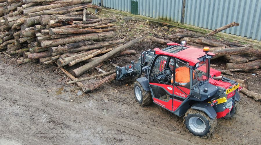 New compact handler moving log pile