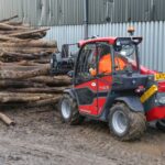 New compact handler moving log pile