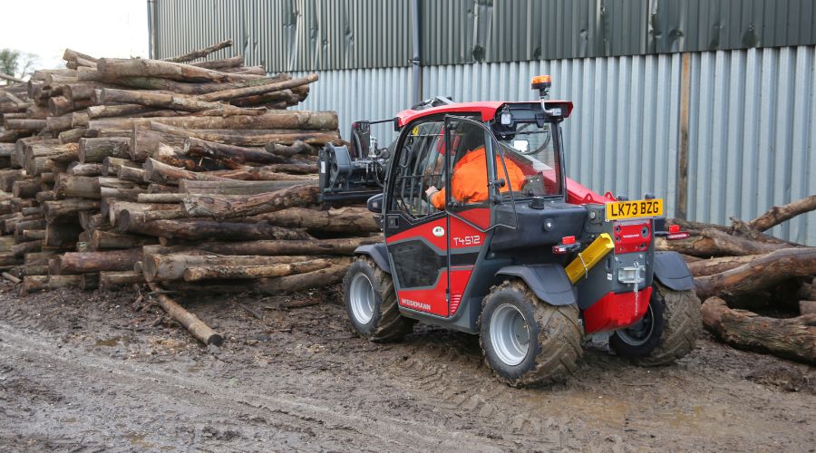 New compact handler moving log pile