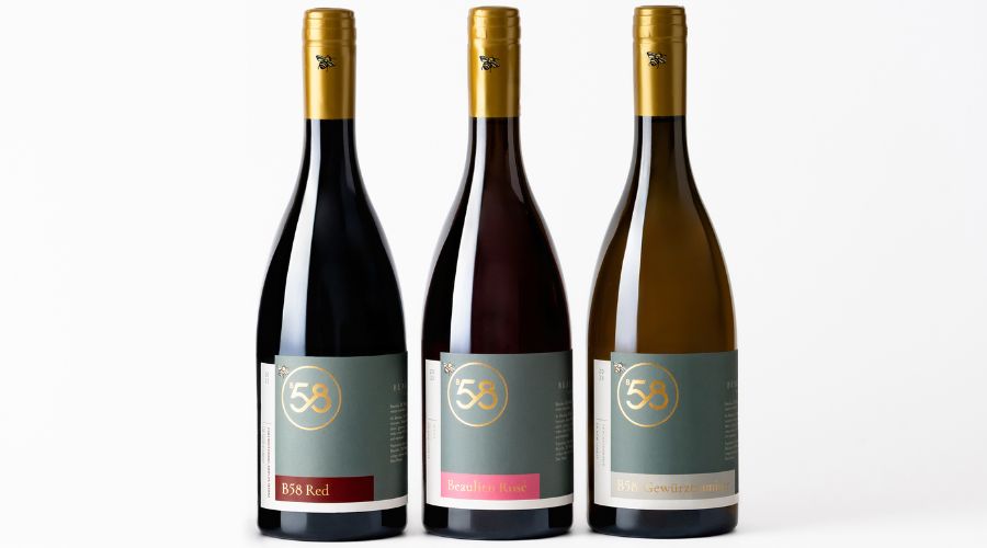 three wine bottles on a white background with grey labels saying B58 in gold in a circle. The first is B58 Red, the second Beaulieu 58 Rose and the third B58 Gewürztraminer.